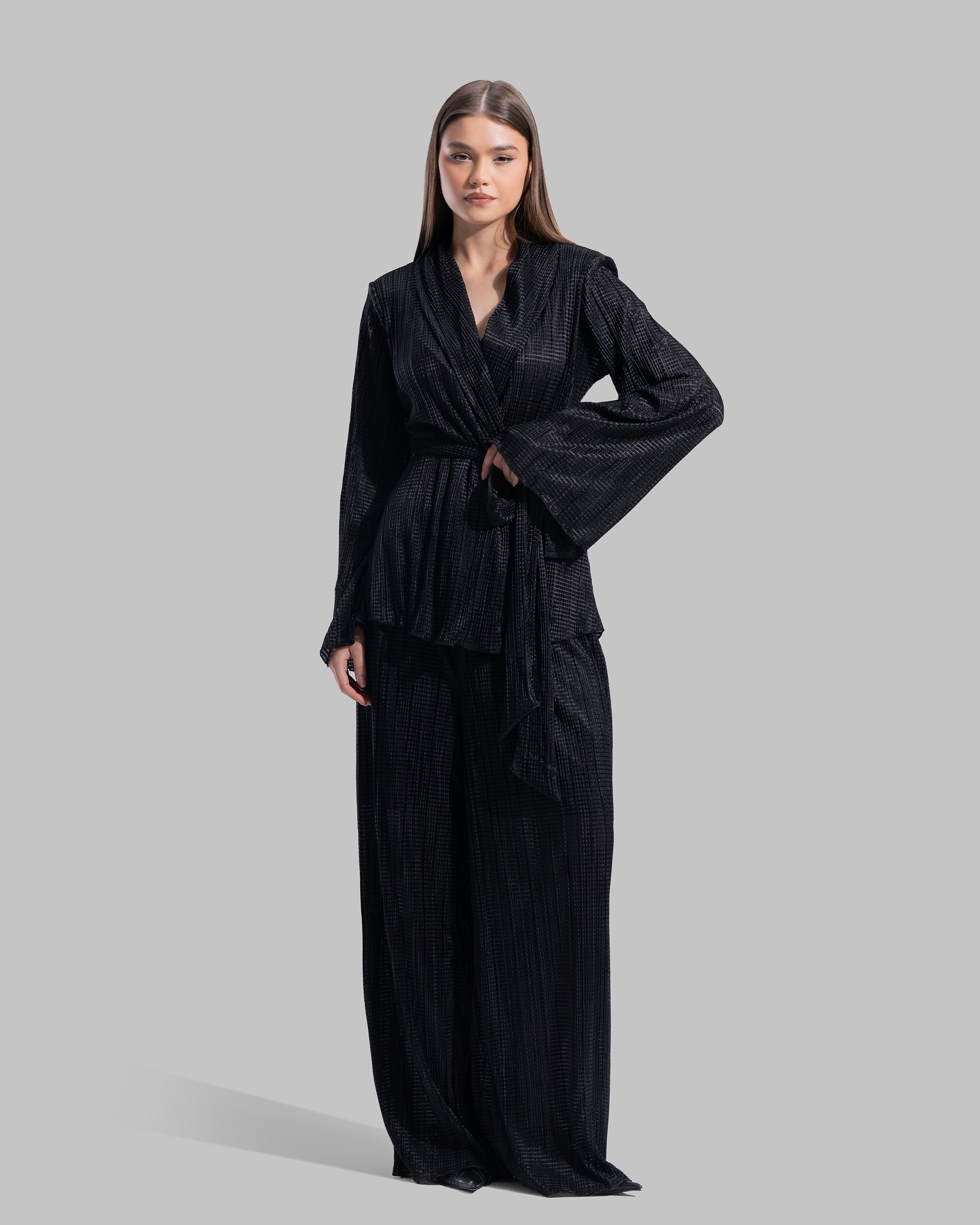 High-waisted wide-leg trousers with an elastic waistband and a textured plissé fabric.