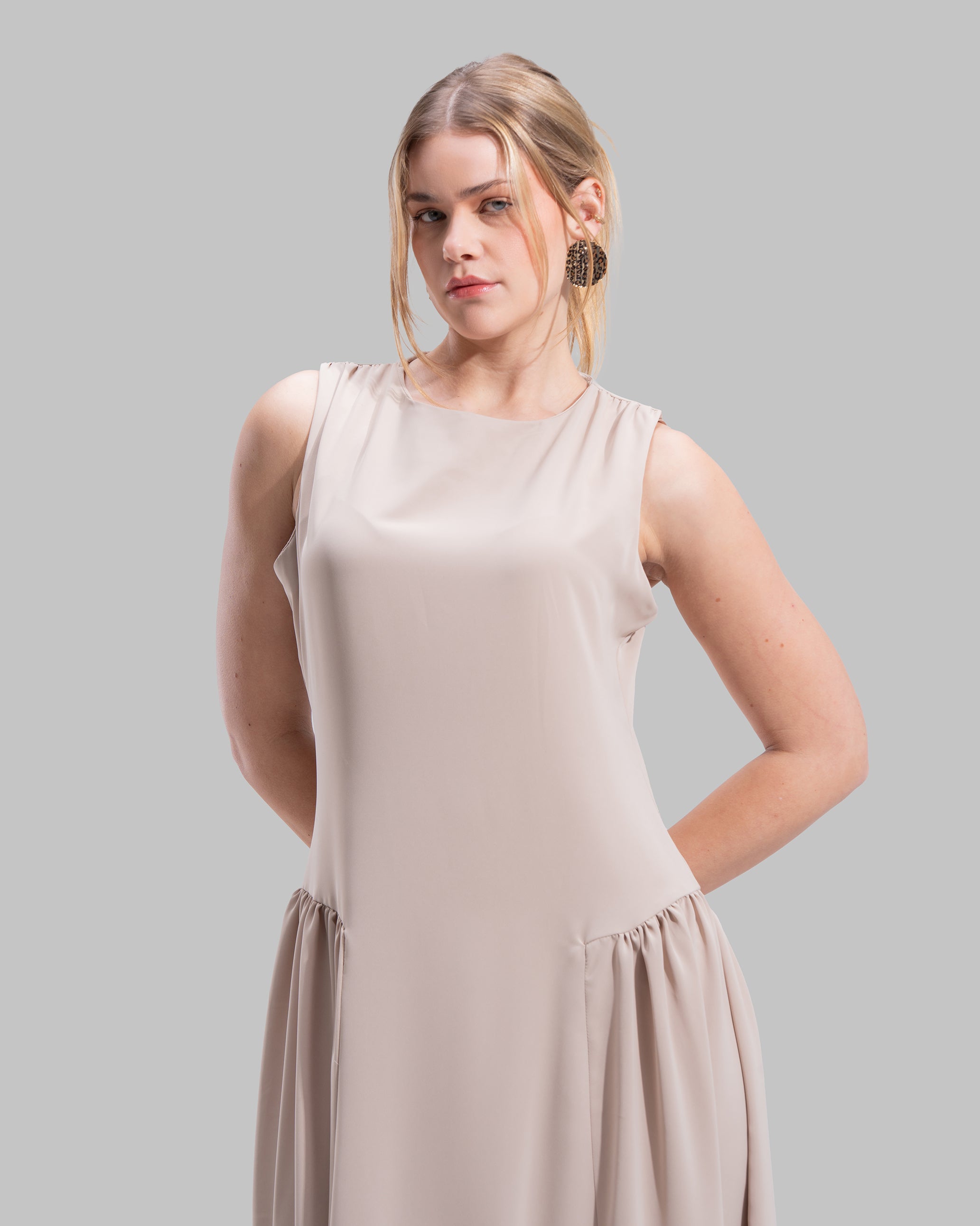Sleeveless long dress with a round neckline.