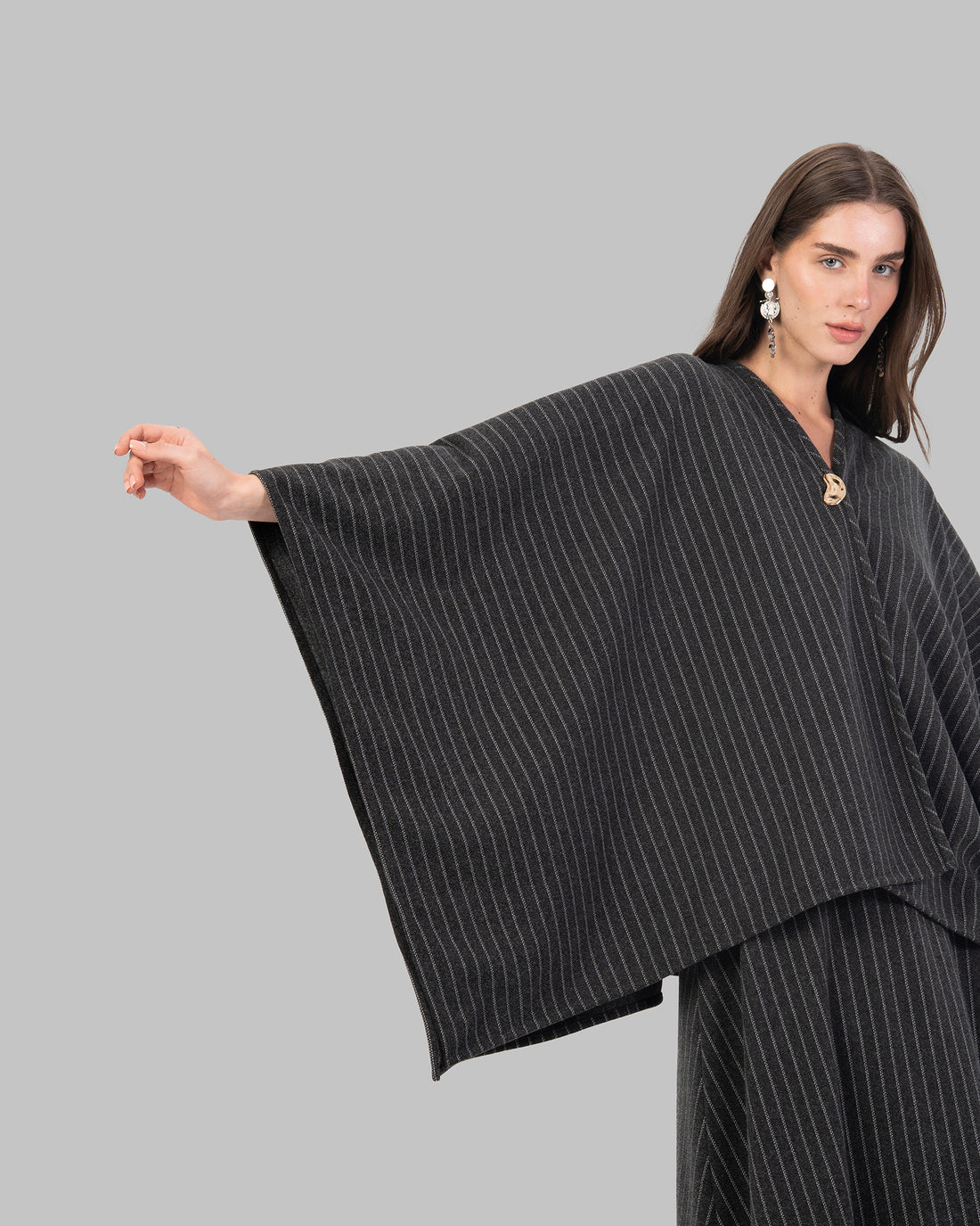 pinstripe poncho with a V-neck and an asymmetric hem.