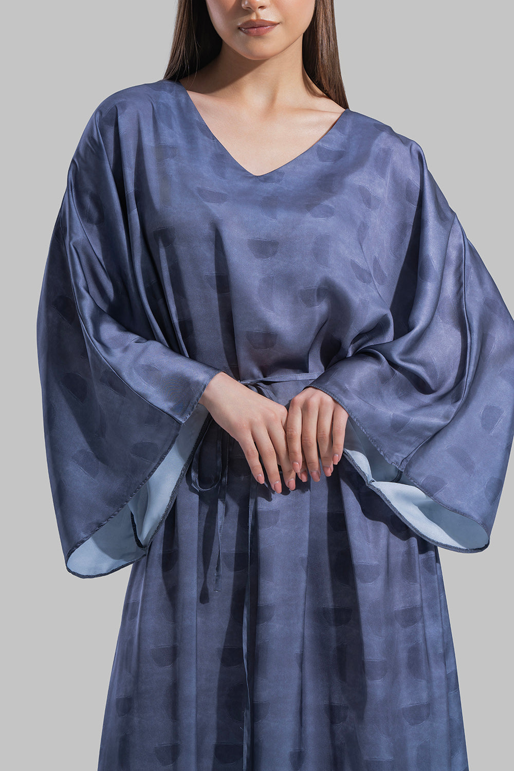 Oversized maxi dress featuring a V-neckline and wide kimono-style sleeves.