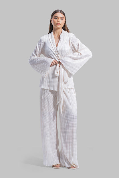 High-waisted wide-leg trousers with an elastic waistband and a textured plissé fabric.