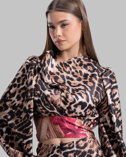 Long sleeve top with a draped neckline and slightly puffed shoulders.