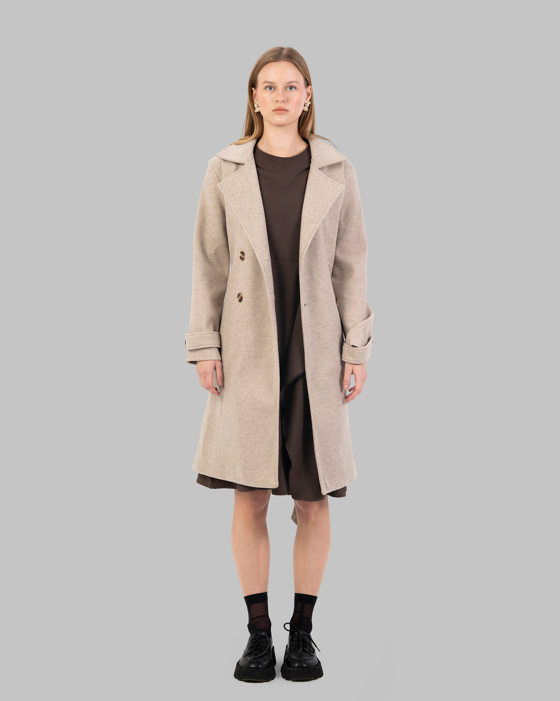 A classic light beige belted coat with a wide collar