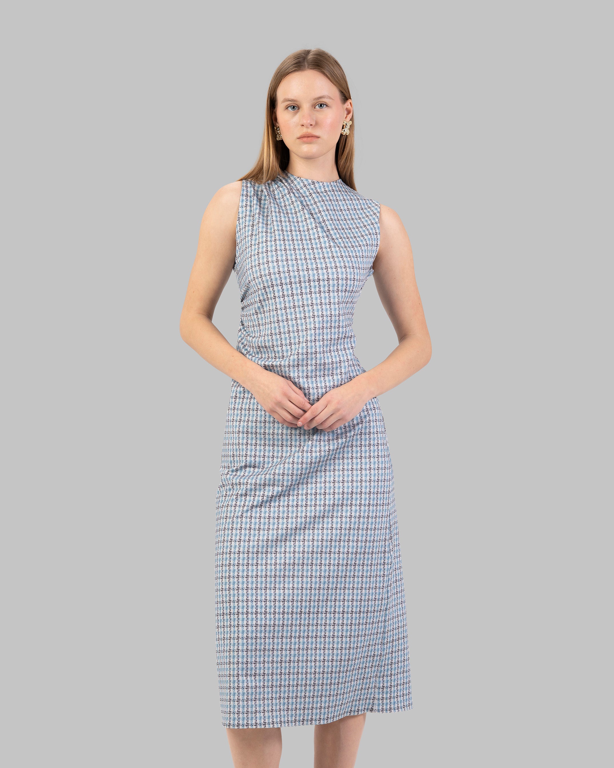 fitted dress with a pink and black houndstooth pattern.