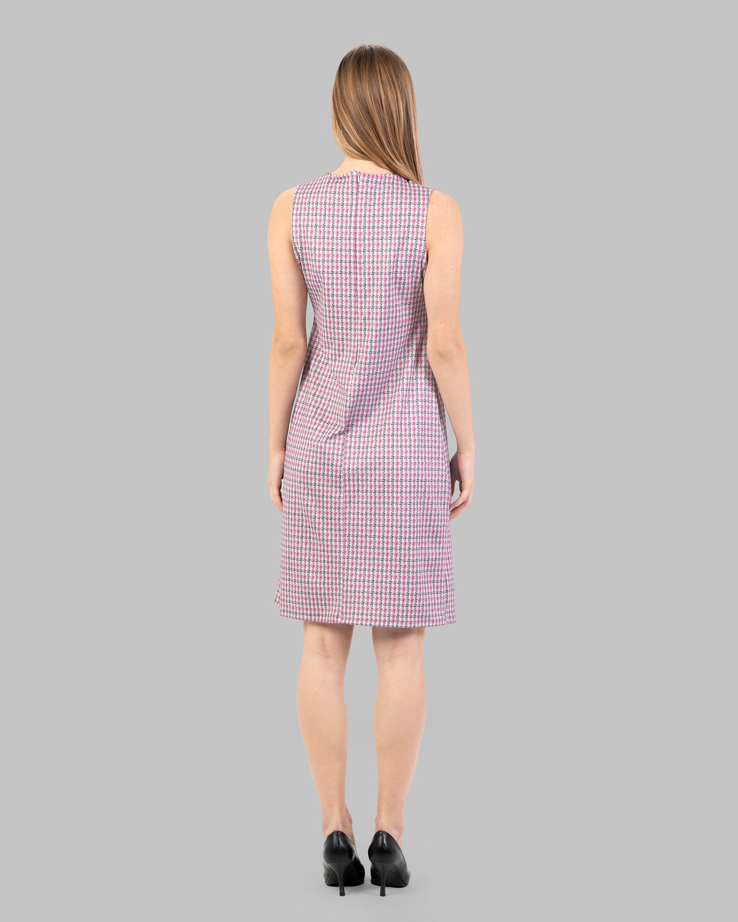 fitted dress with a pink and black houndstooth pattern.