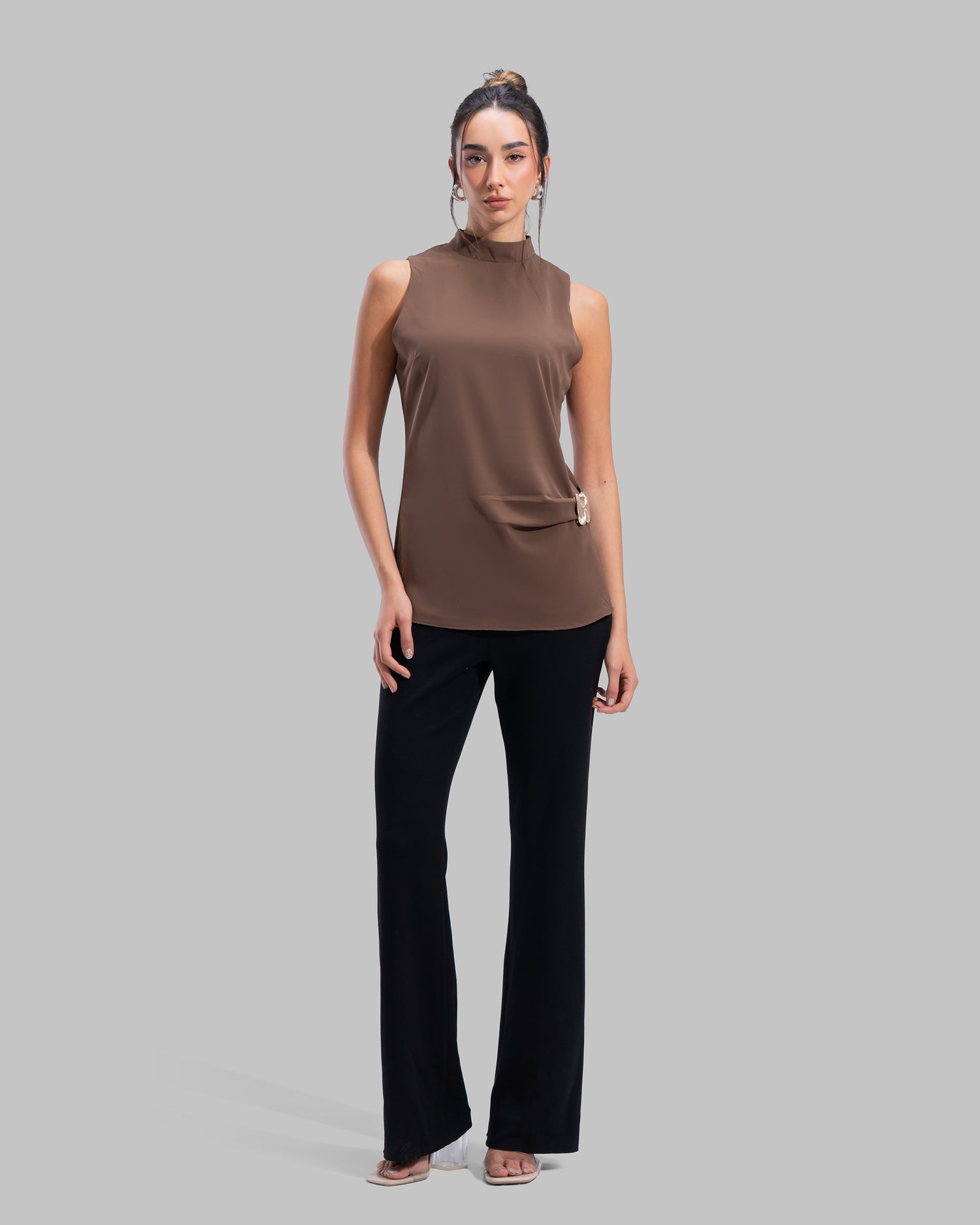 Sleeveless high-neck top with gathered detail and a metallic side buckle.