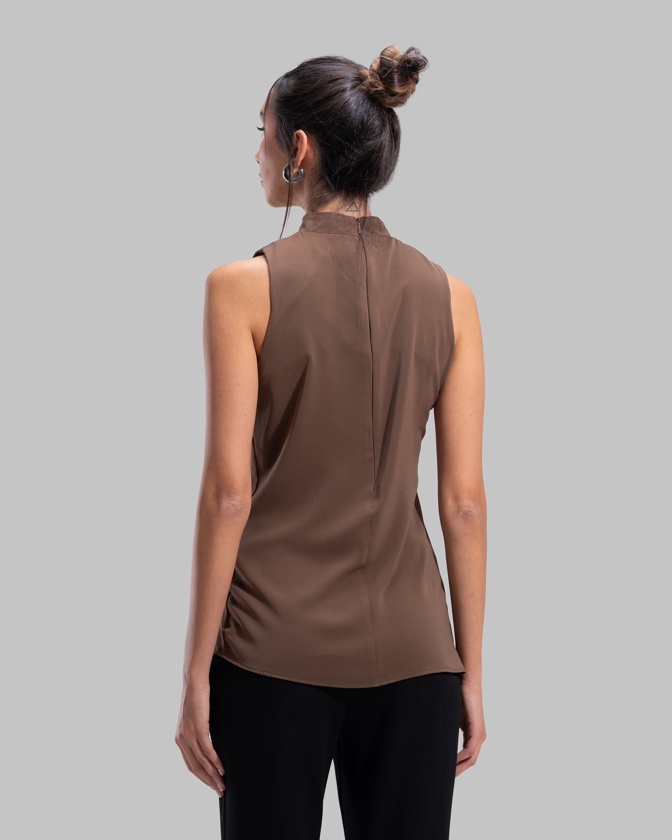 Sleeveless high-neck top with gathered detail and a metallic side buckle.