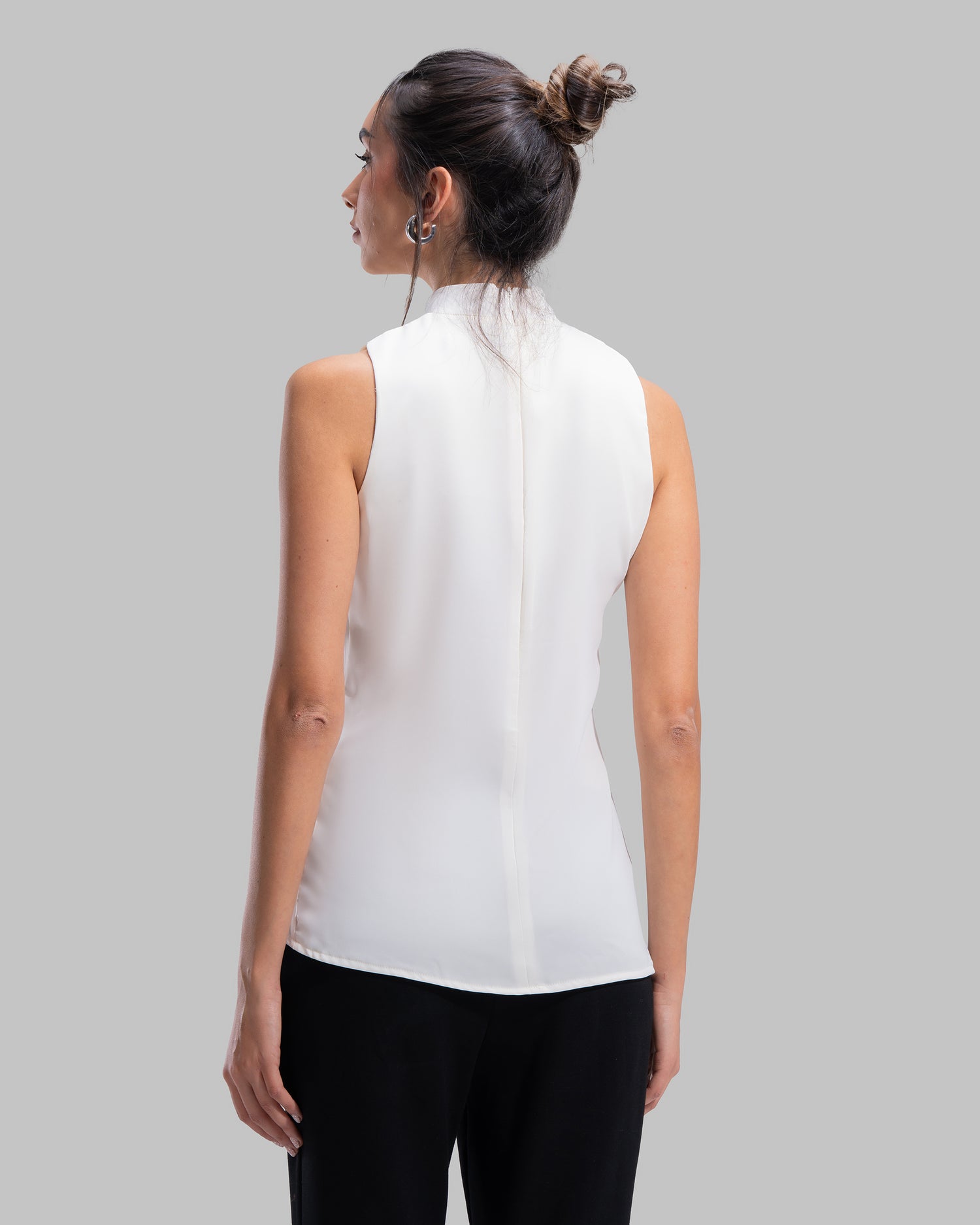 Sleeveless high-neck top with gathered detail and a metallic side buckle.