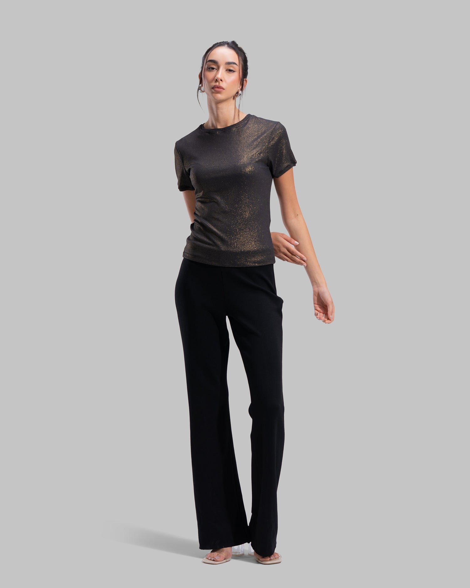 Short sleeve ribbed top with a shimmering metallic finish and round neck.