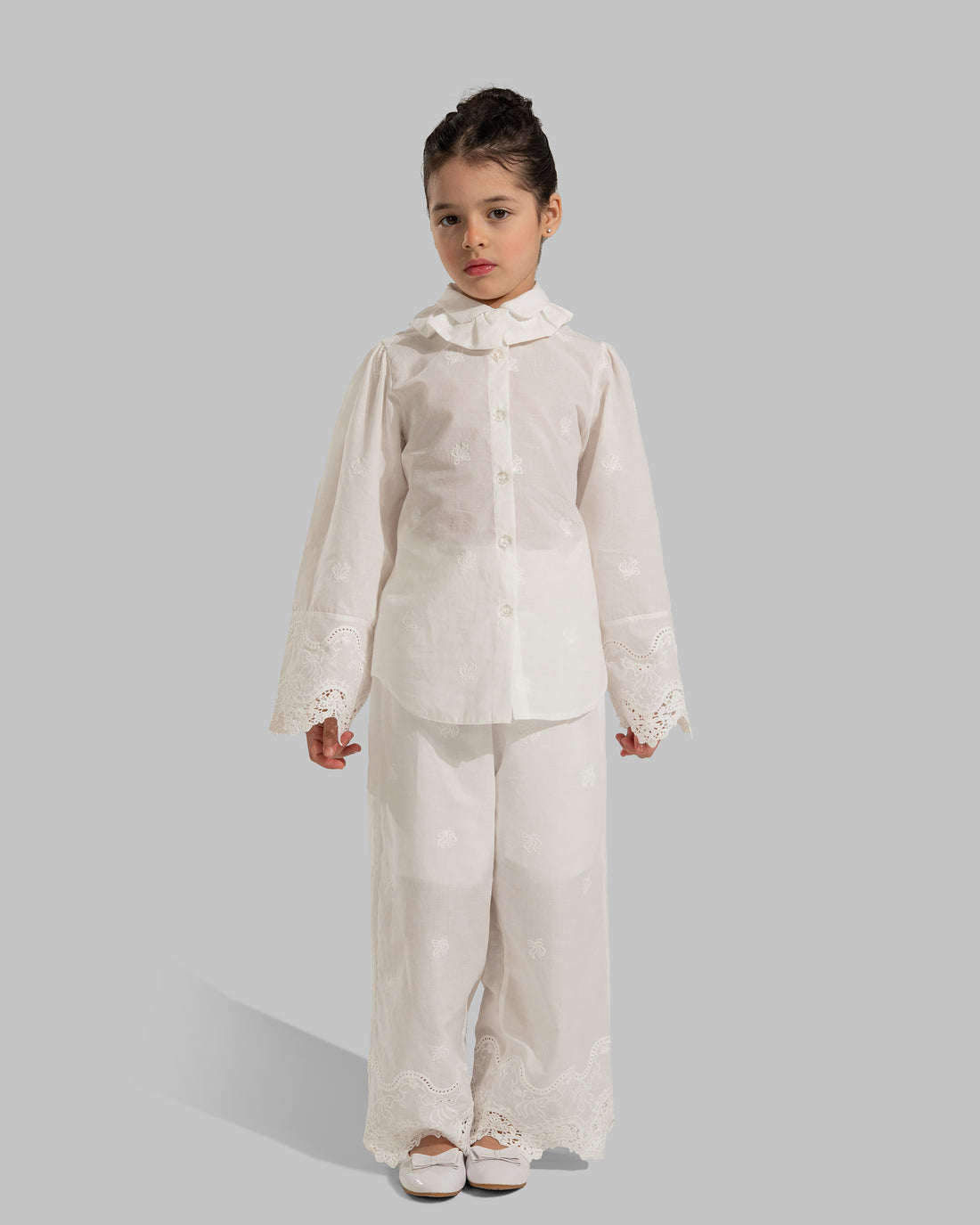 Button-up blouse with a ruffled collar and embroidered lace cuffs.