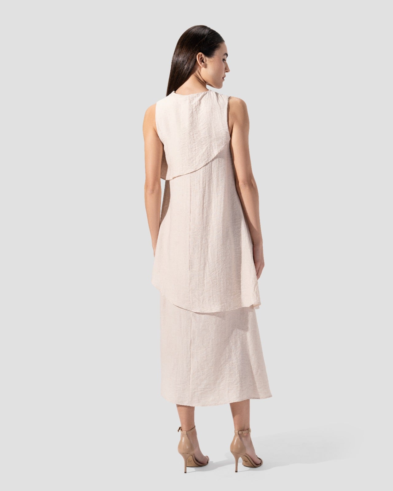midi dress. round neck and sleeveless with ruffeld hem