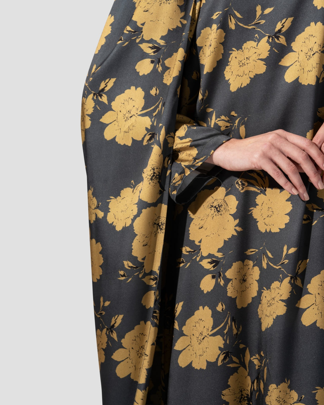 loose dress with a floral print of golden flowers .