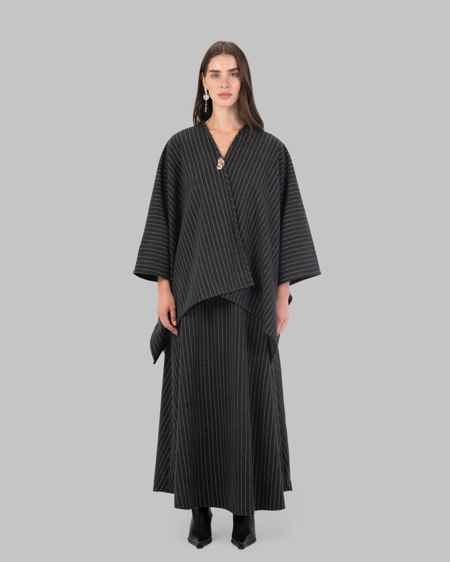 pinstripe poncho with a V-neck and an asymmetric hem.